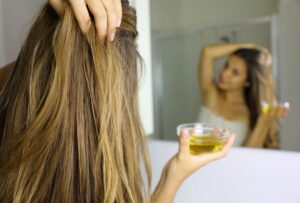 Woman-using-a-good-type-of-olive - Daily Health Tips: Simple Tricks for a Healthier Life Olive Oil Hair Treatments